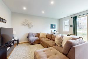 a living room with a couch and a television at Modern Gem in Gypsum in Eagle