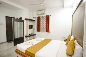 a bedroom with a large bed in a room at HOTEL ANAND in Ratnagiri