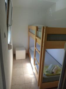 a small room with two bunk beds in a room at Apartments Šešo in Pag