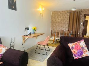 a living room with a couch and a table at Milimani apartments10 in Nakuru +32 photos