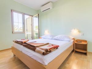 a bedroom with a bed with towels on it at Apartment and rooms Kristina in Baška