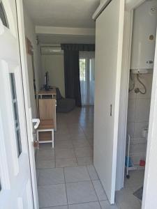 a hallway leading to a living room with a tile floor at Apartments Šešo in Pag