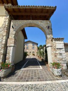 a stone archway with a building in the background at Garda Paradise Country House in Lonato