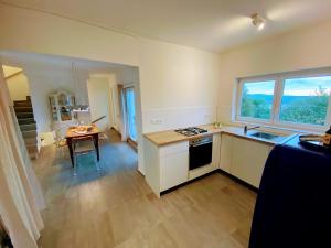 a kitchen with a sink and a table and a window at Einzigartiges Haus mit wunderbaren Seeblick auf Lago Maggiore in Massino Visconti