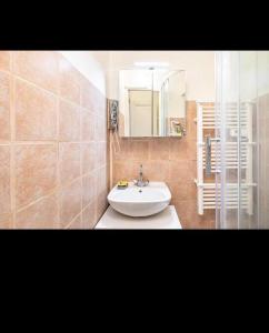 a bathroom with a white sink and a mirror at Appart Paris vue Tour Eiffel in Paris