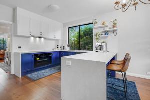 a kitchen with blue cabinets and a white counter top at Private Paradise in Keysborough with pool in Keysborough