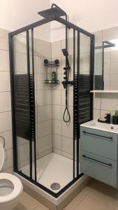 a shower with a glass door in a bathroom at Appartement Cosy Centre Nice in Nice