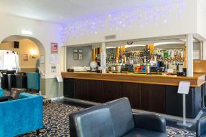 a bar at a hotel with blue chairs at Trecarn Hotel in Torquay