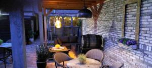 a patio with tables and chairs and a couch at De Vier Seizoenen in Renesse