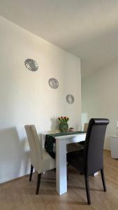 a dining room with a table and two chairs at Apartman SunShine in Trebinje
