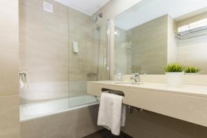 a bathroom with a sink and a shower at Acacias Apartamentos Salou in Salou