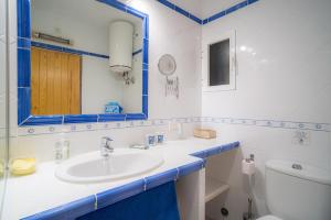 a bathroom with a sink and a mirror and a toilet at Mirada I in Es Pujols +22 photos
