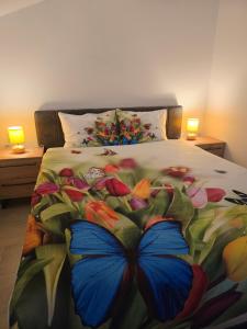 a bedroom with a bed with a butterfly on it at Vila Nemir Zavojsko jezero in Pirot