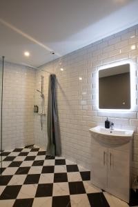 a bathroom with a sink and a flat screen tv at The Abbeygate Townhouse in Galway