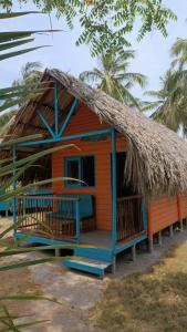 een klein huis met een rieten dak bij Hotel Las Casitas De Mar Adentro in Isla Grande
