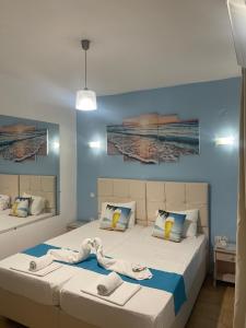 a bedroom with two beds with towels on them at Pansion Katerina in Skala Eresou