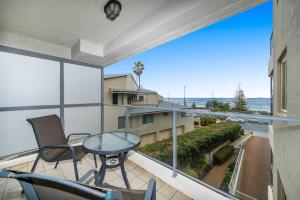 a balcony with a table and chairs and a view of the ocean at Sandcastles At The Beach Outstanding Location! in Perth