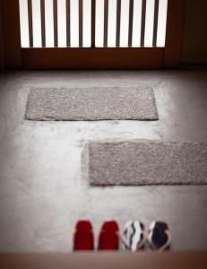 a group of shoes on the floor in front of a door at Samurai Suite 2 , 15mins from Kyoto Eki , 5 mins to Arashiyama in Kyoto