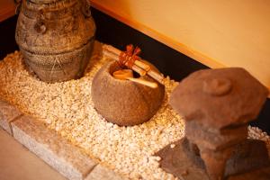 a bowl of food sitting on top of gravel at Samurai Suite 2 , 15mins from Kyoto Eki , 5 mins to Arashiyama in Kyoto