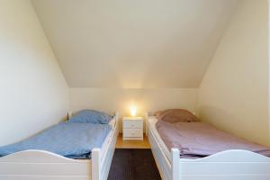 two beds in a small room with a light on it at Ferienwohnung in Spelle in Spelle