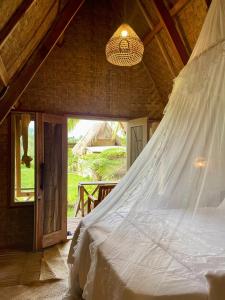 a bedroom with a bed with a mosquito net at Girang Rinjani Bungalows in Tetebatu