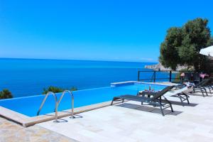a swimming pool with a view of the ocean at Villa Smiles in Patara