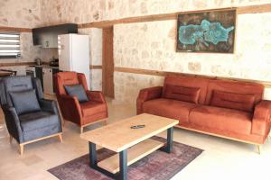a living room with a couch and two chairs and a table at Villa Smiles in Patara