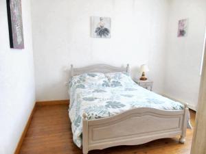 a bedroom with a bed with a blue and white comforter at Maison de 2 chambres avec wifi a Avesnes en Val in Avesnes-en-Val