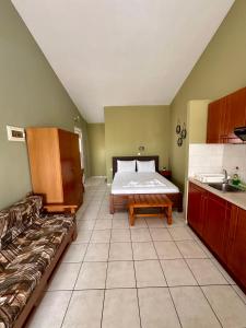 a room with a bed and a couch in it at Artemis Hotel Apartments in Keramotí +9 photos