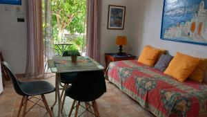 a bedroom with a bed and a table and chairs at poros apartment in garden in Poros