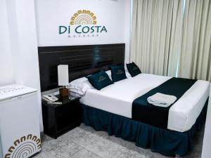 a hotel room with a bed with a sign on it at Di Costa Hoteles in Piura