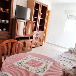 a living room with a table and a tv at 2 bedrooms house at Ciudad Real in Ciudad Real