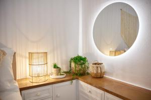 a bathroom with a mirror and a counter with plants at Casa Castello Chios in Vrontados