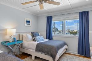 a bedroom with a bed and a window at Bottoms Up! in Atlantic Beach