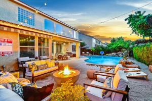 an outdoor patio with a fire pit and a pool at Enchanting Clovis Haven with Hot Tub and Private Pool! in Clovis