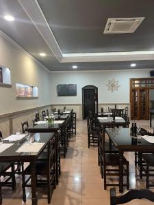 a restaurant with tables and chairs in a room at Hostal-Restaurante San Roque in Verín
