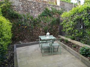 a table and chairs in front of a wall at Borgo dei vigneti in Montecarlo