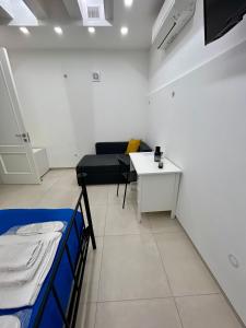 a room with a bed and a table and a couch at Vesuvia B&b Luxury Living Pompei in Pompei +31 photos