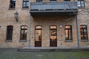 a brick building with windows and a balcony at SweetHome - Luxus pur - große Küche, Terrasse, Stellplatz, WiFi in Halle an der Saale