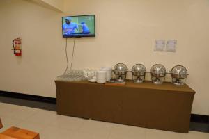 a counter in a room with plates and a tv at River View Hotel Shigar in Shigar +49 photos