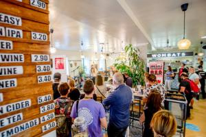 a crowd of people standing in a store at Wombat's City Hostel Vienna Naschmarkt in Vienna