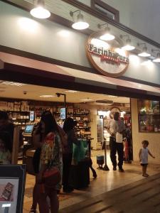 a store with people standing inside of a store at Apartamento Parque Jardim Europa in Rio de Janeiro