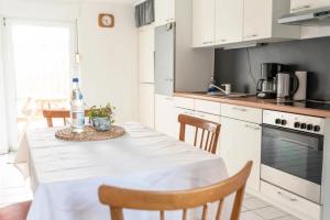 a kitchen with a table with a white table cloth on it at Ferienhaus Steinhoff in Marsberg