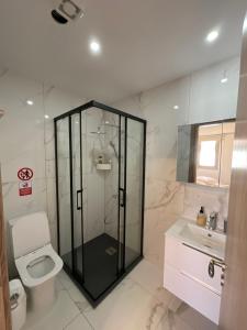 a bathroom with a shower and a toilet and a sink at Le Voyageur II in Larnaca +19 photos