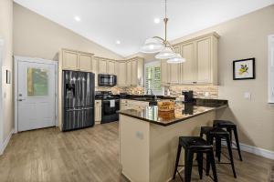 a kitchen with black appliances and a counter top at Citrus Hideaway - Steps to City Center in St. Augustine