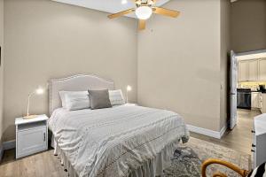 a bedroom with a bed and a ceiling fan at Citrus Hideaway - Steps to City Center in St. Augustine