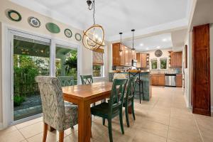 a kitchen and dining room with a wooden table and chairs at Casa DeSoto - Luxury Downtown Oasis in Saint Augustine