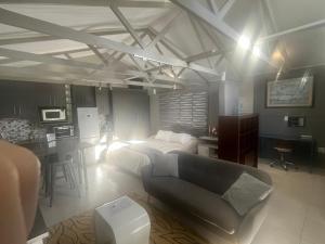 a living room with a couch and a table in it at 28 on Symonds Luxstudio 5 in George