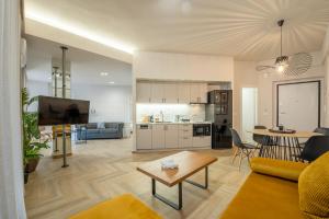 a living room with a couch and a table at Dreamin Athens - Monastiraki Apartments in Athens