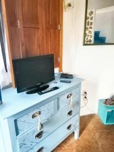 a dresser with a television on top of it at One bedroom house with shared pool enclosed garden and wifi at Nazare 7 km away from the beach in Nazaré